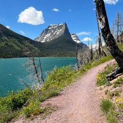 Hiking the trail along St Mary Lake. The water is that blue from suspended glacial sediment.