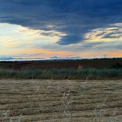 Mountains in the distance and dark clouds on the Horizon