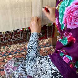 Weaver making a rug.