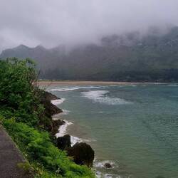 Heading out along the coast into the mist and rain