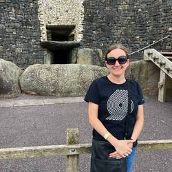 Newgrange burial mound, which is larger than Knowth. Diana for scale.