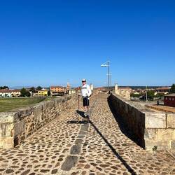 John crossing the Roman bridge into Hospital de Orbigo