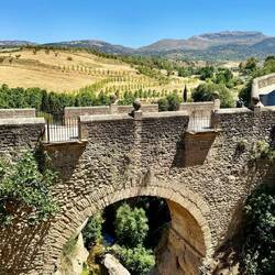 Another bridge in Ronda, older than the famous one. And beautiful countryside in background.