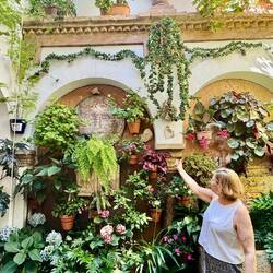 The woman in the picture is the owner of this house/garden. She proudly tells us about her plants.