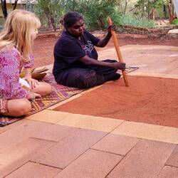 Tina explaining some of the Aboriginal art symbols ... Maruku Dot Painting class — Yulara