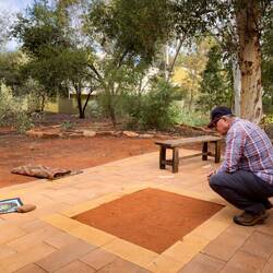 Mui checking out the dirt scratching from this morning's Maruku Dot Painting class — Yulara, NT.