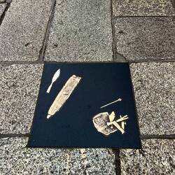 These plaques in the ground depict Viking objects found below the ground
