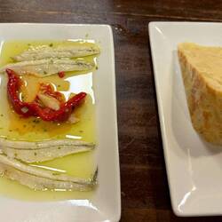 Anchovies on the left and a torta on the right (potatoe/egg pie).