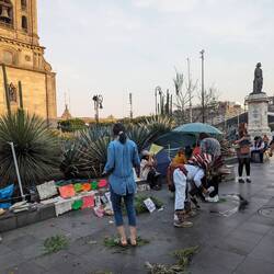 A witchdoctor performing a cleaning ritual in front of the cathedral