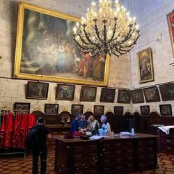 Sacristy. Priests disrobing. Notice the old artwork
