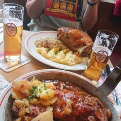 Braised pork with beer and mushroom sauce, smoked and roasted pork knuckle with sauerkraut