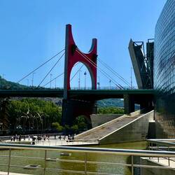 The museum has several large architectural elements outside, including a bridge and a tower.