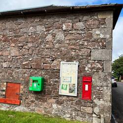 Defibrillator and post box on an apparently random wall