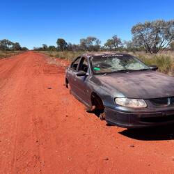 One of dozens of damaged cars alongside the track