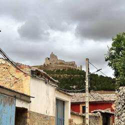A castle ruin atop the mountain above the village of Catrojeriz