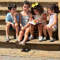 These kids were sitting on the market stairs talking about a book- so cute!