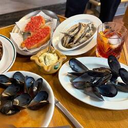 Braised beans, tomato toast, fried anchovies and mussels.