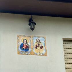 Many houses have beautiful religious tiles near the doors