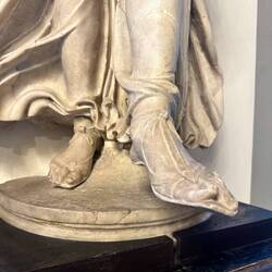 Rare view of a sculpture's fashionable feet