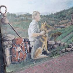 Werbung für eine Albergue an einer Hauswand.