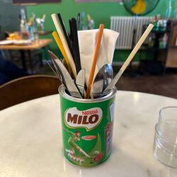 Old school cutlery presentation featuring a used milo tin.