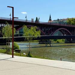 Drava River walking bridge with larger bridge behind it