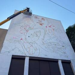 A wall mural being painted in Paris Chinatown.
