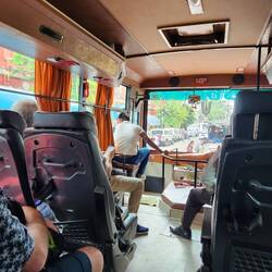 The bus drivers helper telling people to get out of the way