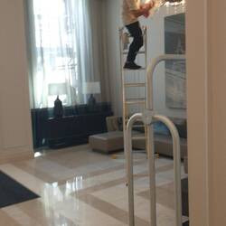A different picture, someone cleaning a chandelier