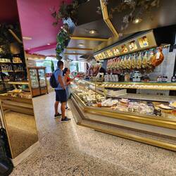 A delicatessen with beautiful hams hanging