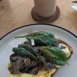 Stacked up scrambled eggs on toast