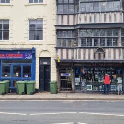 Historical building housing the Tourist Information right next to a USA Chicken joint