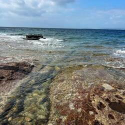 Rocky beach by Calasetta harbour.
