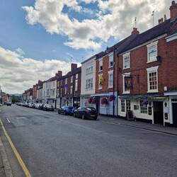 High street with yellow and purple banners to celebrate the plum festival