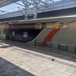 A double decker sleeper train at the train station.