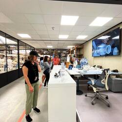 The painter in the background painting while the tours look on