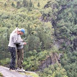 A metaphor for the youth of today -- on the precipice but looking at their phones