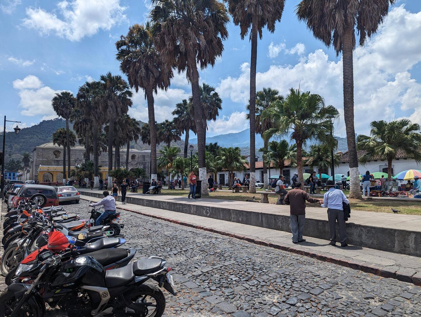 A square in Antigua with the volcanoes in the distance