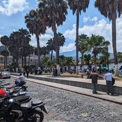A square in Antigua with the volcanoes in the distance