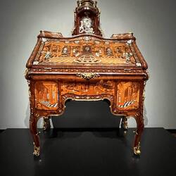 This desk is one with secret compartments. Also it reflects the interest of the man who commissioned