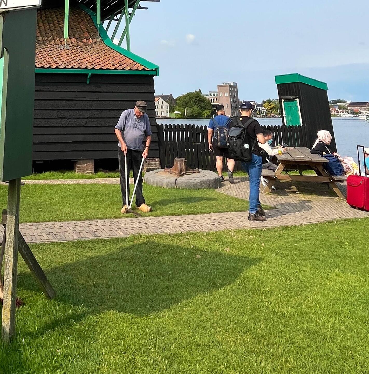 Lawn edger by hand, he is working in clogs which seemed to be his "work" shoes