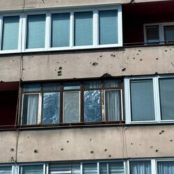 Shrapnel holes are on most buildings, particularly along ""Sniper Alley"