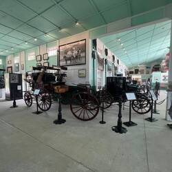 Some of the museum carriages inside the Grand Hotel Carriage House.