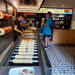 Assembly line of yumminess. Fresh baked cones for ice cream and fruit fillings