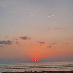 Sonne geht auf der anderen Seite hinter den italienischen Bergen unter