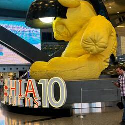 A 23-foot canary yellow teddy bear sculpted from bronze, that sits peacefully inside a lamp.