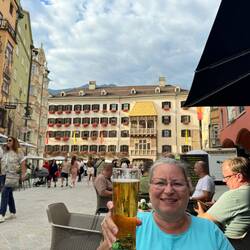 Lea with a Radler in front of the gold roof house