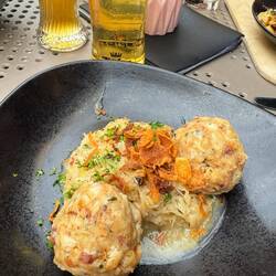 Bacon dumplings with sauerkraut topped with fried onions