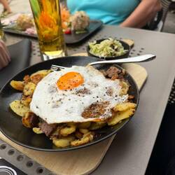 Potatoes, slices of roast pork, egg, and spaetzle