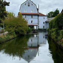 Cute house and lazy river through the center of Erding